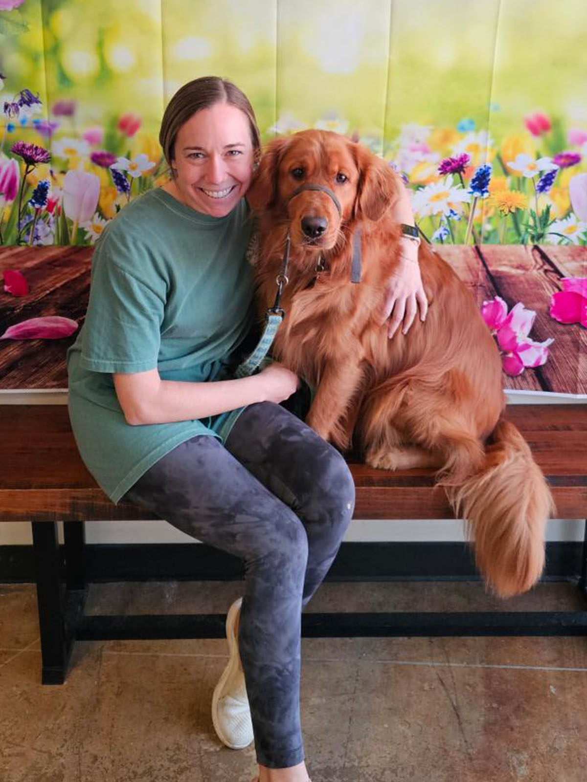 a person sitting on a bench with a dog